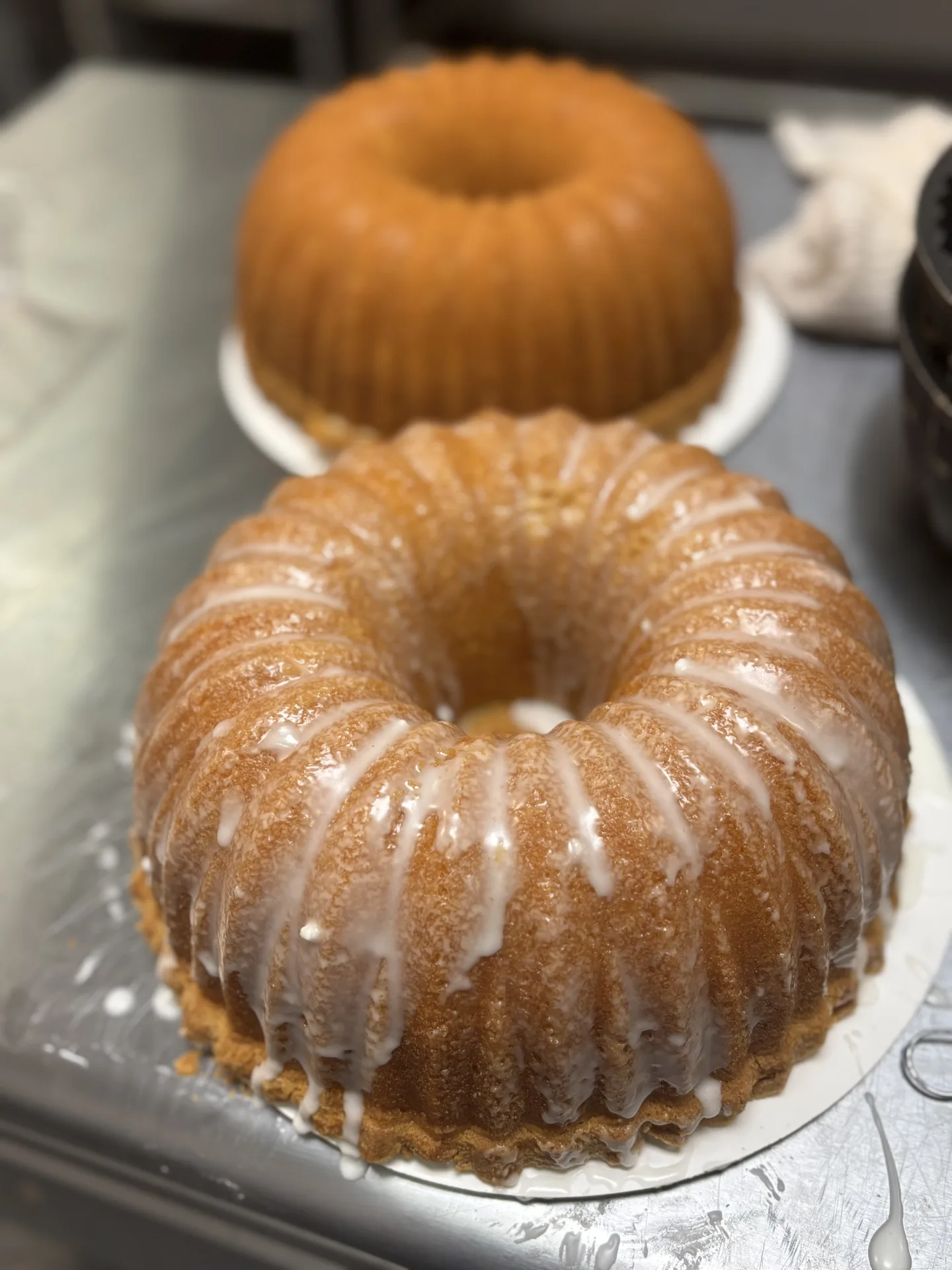Hand-glazed Bundt cake being finished