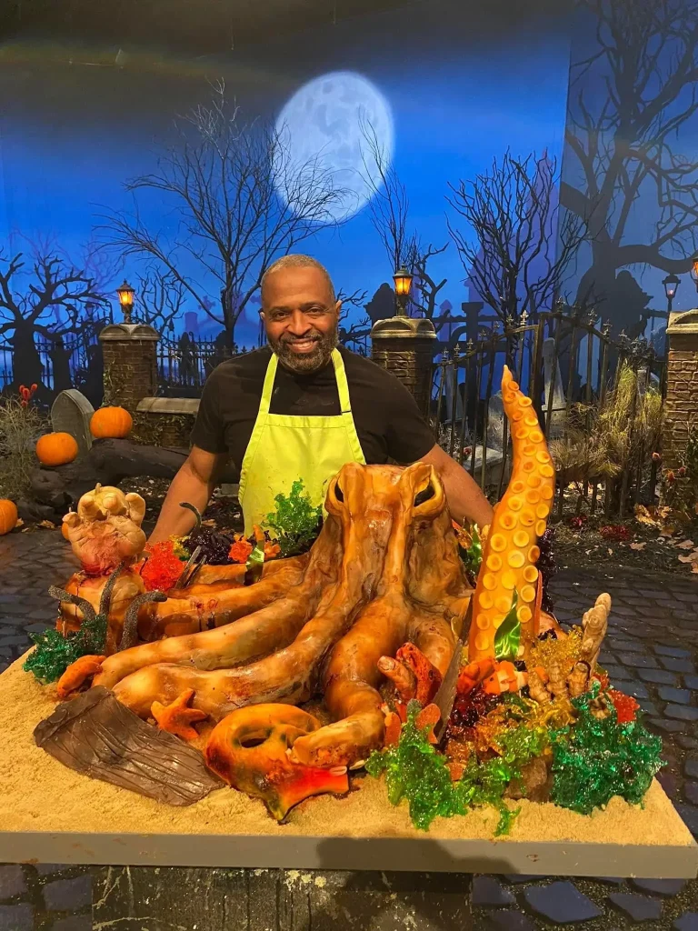 Reggie beside his octopus sugar showpiece on the Halloween Wars set