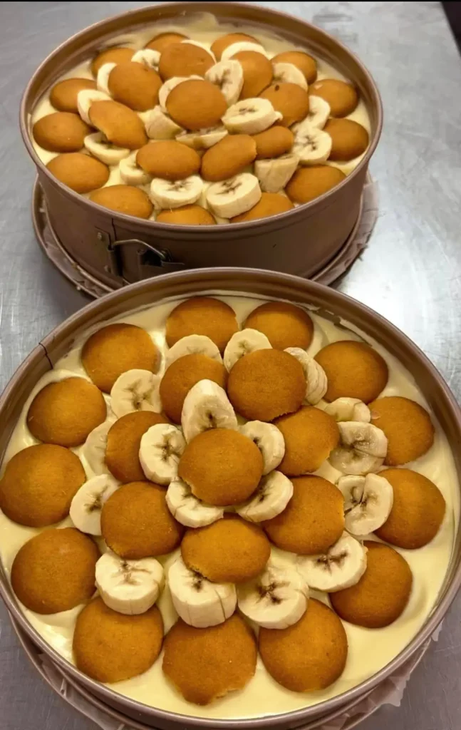Two pans of banana pudding layered with vanilla wafers and fresh banana slices